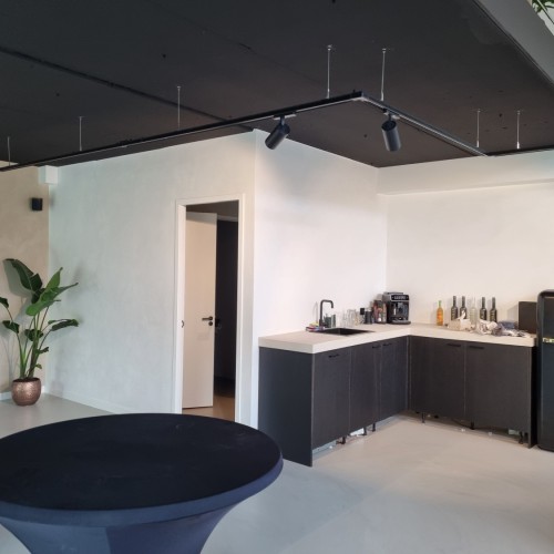 Trackverlichting schijnend op keuken met betonciré werkblad